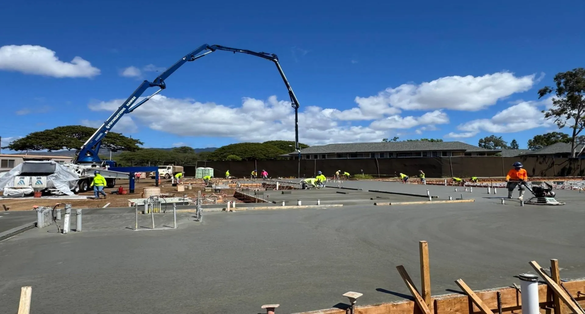 Concrete pump placing the monolithic top slab across an RPS raft